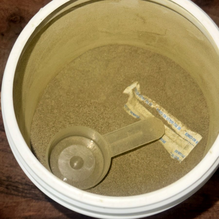 Open tub of immunity superfood powder with scoop