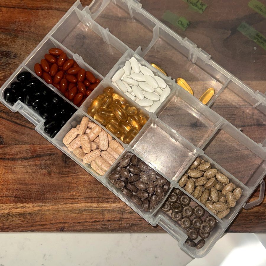 A week of daily supplements sorted in an organizer