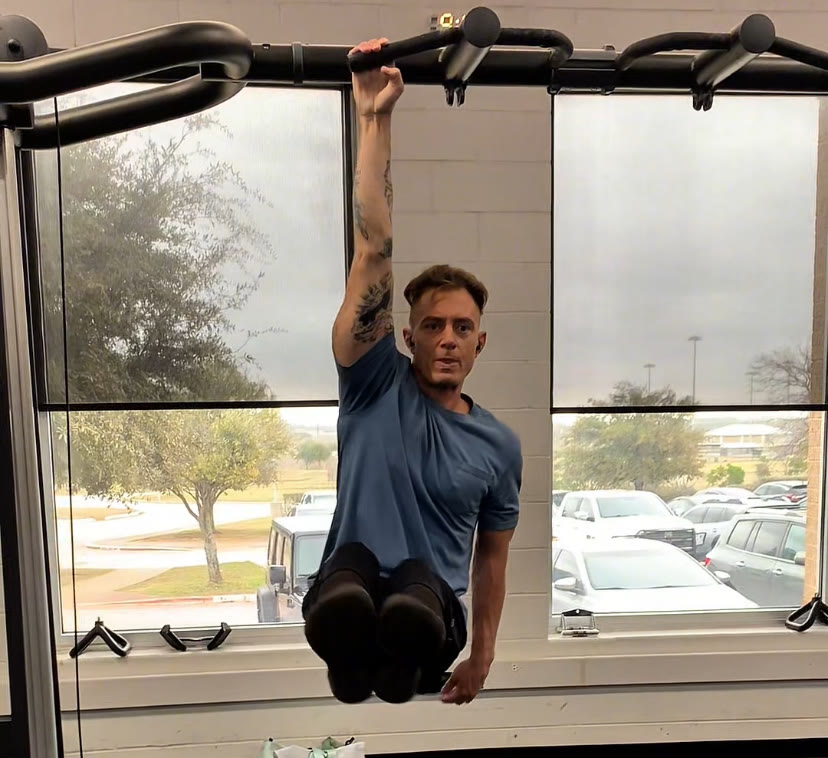 One-arm hang with raised knees, bodyweight strength training