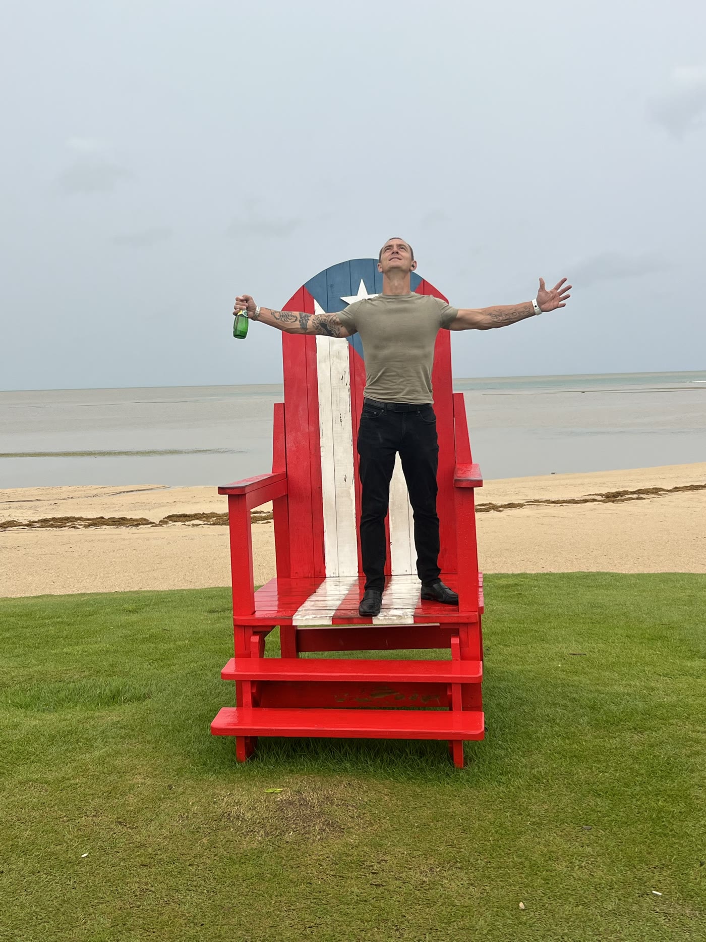 Arms wide on the beach, owning the life rebuilt from rock bottom